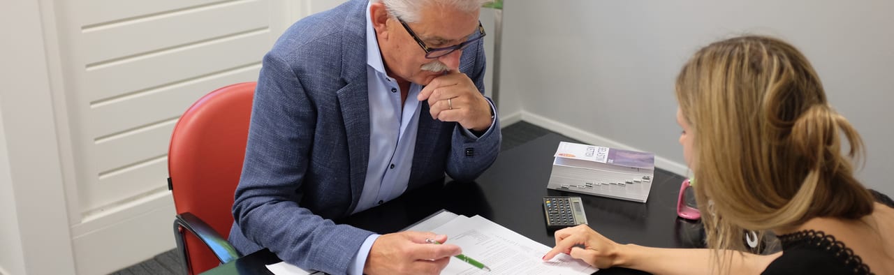 Belastingadviseur in gesprek met een cliënt aan de vergadertafel